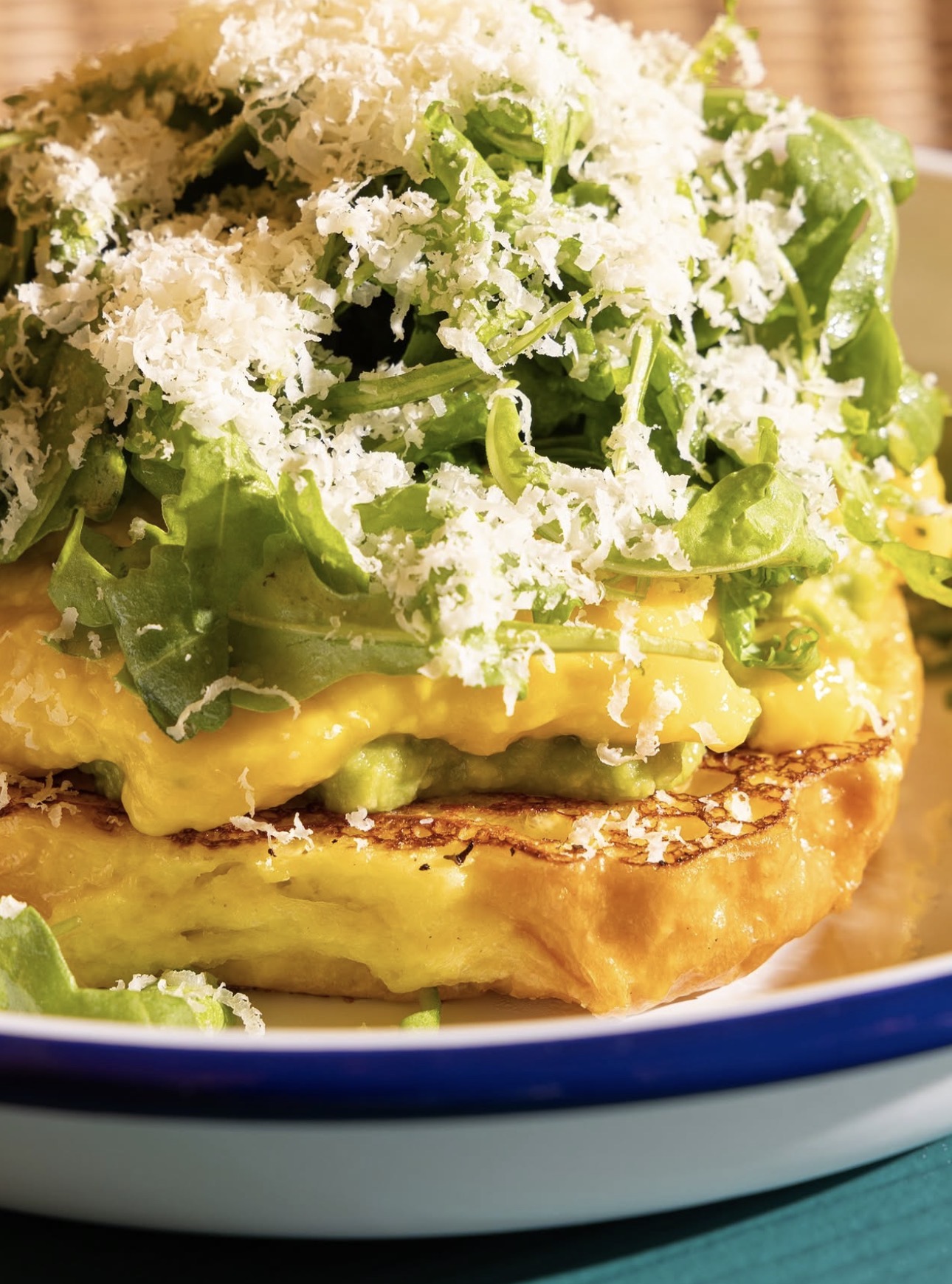 Convitio gourmet dish with greens and grated cheese